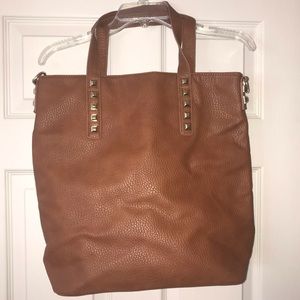 Large brown leather tote bag with gold studs